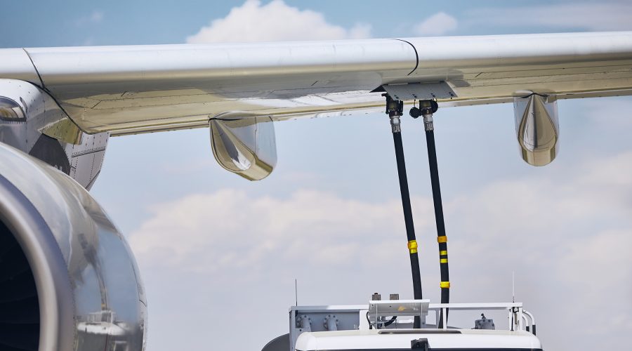 Ground service before flight. Refueling of airplane at airport.